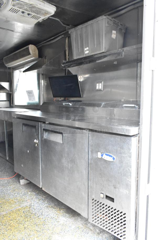 Fully outfitted food trailer interior with stainless steel counters, shelves, and appliances. Excellent condition, ready to use.