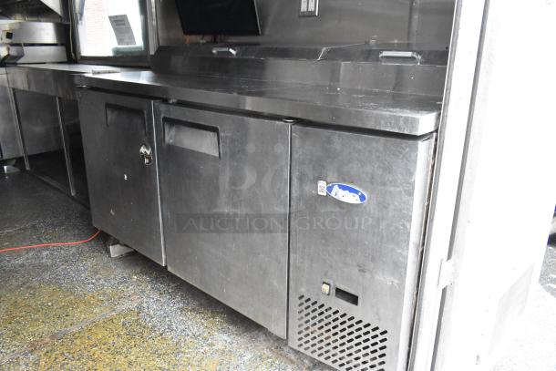 More Than A Dream food trailer interior showing stainless steel storage and work area, equipped and ready for use.