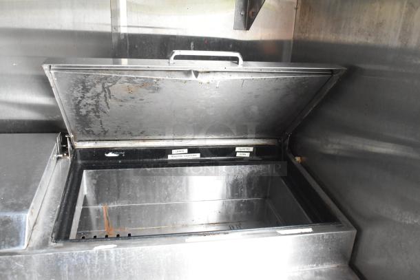 Stainless steel food warmer with labels for lemon, cilantro, roasted tomatoes, and corn. Suitable for food trailer use.