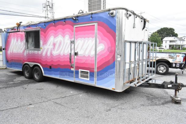 Brightly colored "More Than A Dream" food trailer, fully equipped, ready for business, featuring service window and hitch.