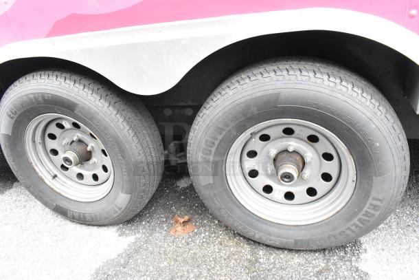 Close-up of double axel wheels on a "More Than A Dream" food trailer, featuring durable tires marked "Ecopath ST".