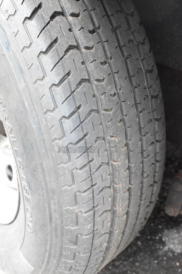 Close-up of the tire on a More Than A Dream food trailer, showing detailed tread patterns indicating good condition.