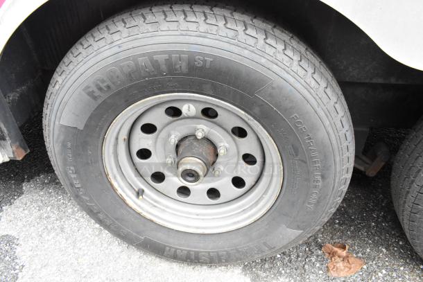 Close-up of Ecopath ST tire on food trailer, marked "For Trailer Use Only." Durable with visible treads, mounted on metal rim.