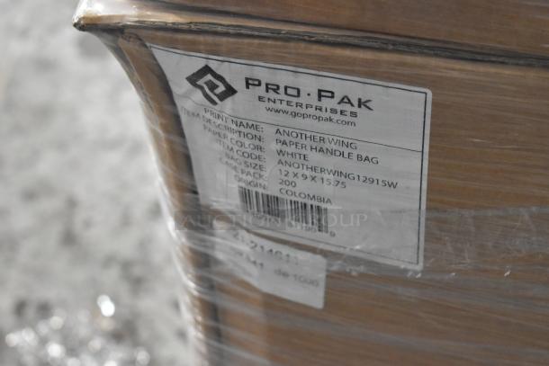 20 boxes of 200 Pro Pak white paper handle bags, new condition. Size 12x9x15.75 inches, origin Colombia.