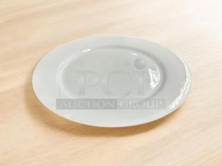 16" white dining plate, like new, made in China. Smooth surface, no visible marks or chips.