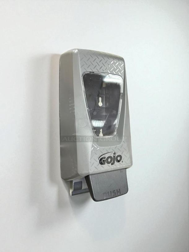 Brand new GoJo PRO TDX 5-3/4" black plastic wall mount foam hand soap dispenser. Logo and "PUSH" visible.