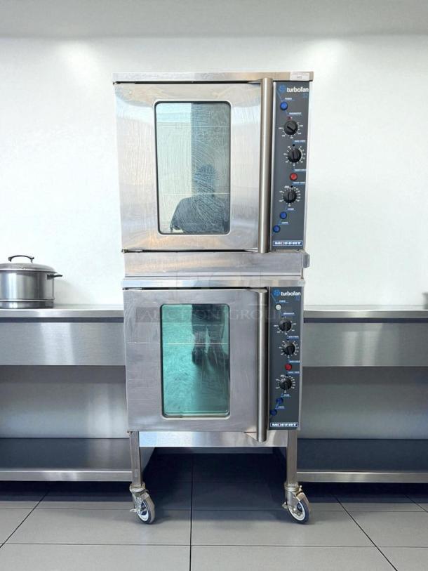 Double stacked Moffat Turbofan E32MS/2 electric convection ovens, excellent condition, stainless steel, on caster wheels.