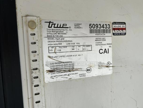 True TWT-27F Work Top Freezer label showing model, serial number 5093433, voltage, and refrigerant details. Made in the USA.