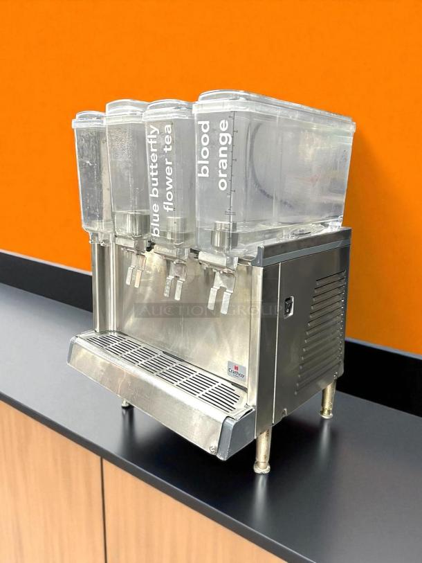 Crathco CS-4E-16-290 refrigerated drink dispenser with four 2.4-gal bowls, labeled "blue butterfly flower tea" and "blood orange." Fully tested.