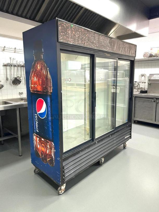 True GDM-69 black refrigerated sliding glass door merchandiser, 78 1/8", fully tested, excellent condition, Pepsi branding.