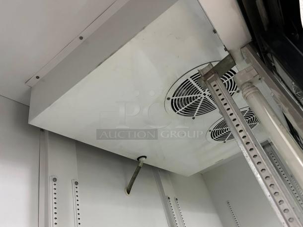 True GDM-69 black refrigerated sliding glass door merchandiser interior, fully tested, excellent condition.