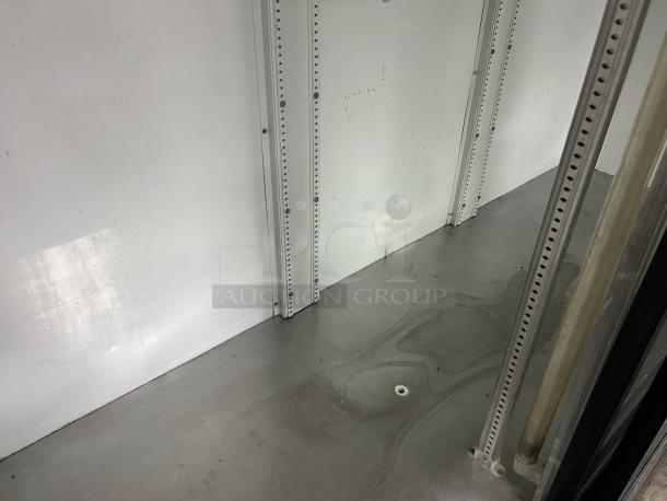 True GDM-69 refrigerated sliding glass door merchandiser interior, black frame, excellent condition, fully tested.