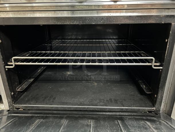 Atosa AGR-6B gas range oven interior, includes a wire rack. Condition appears clean and well-maintained.