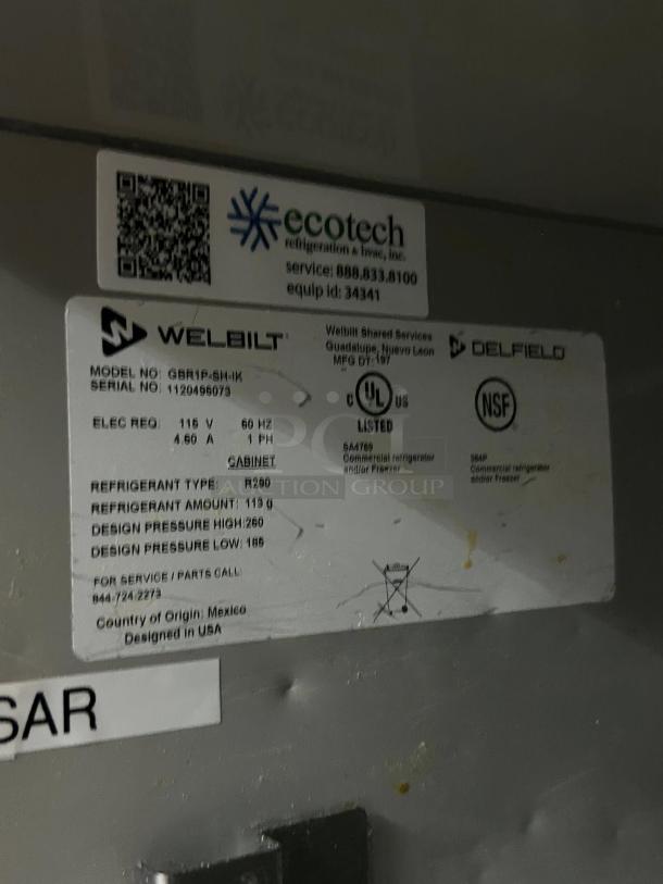 Delfield GBR1P-SH refrigerator label showing model, serial number, 115v power, R290 refrigerant, and Ecotech service info.