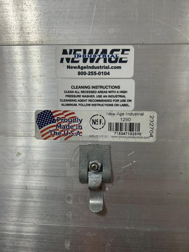 New Age Industrial 129PH full-size enclosed bun pan rack, holds 40 pans. Shows metal finish, labels for cleaning, "Made in USA."