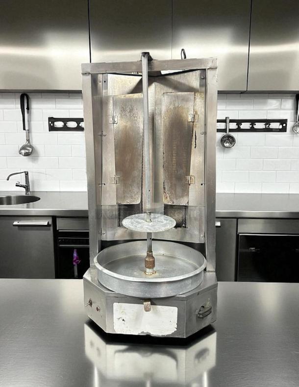 Autodoner 3-PG vertical broiler, 65 lb capacity, gas-powered, tested and working, excellent condition, in kitchen setting.