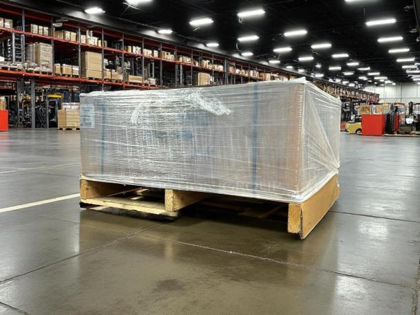 New in box American Range AERB-36 gas charbroiler, 36" wide, with 6 burners, securely wrapped on a pallet in a warehouse.