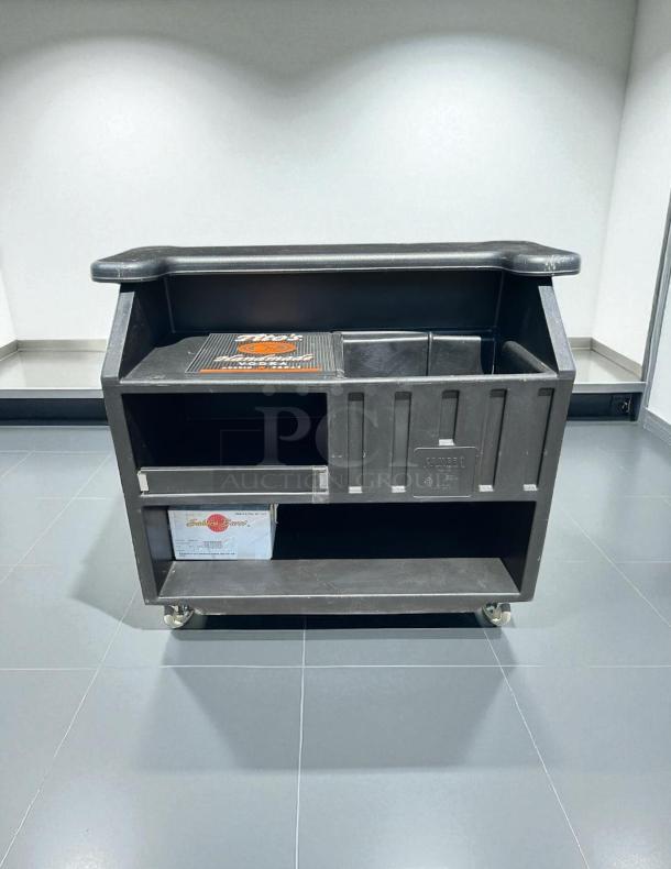 Cambro BAR540110 Cambar® Black 54" Portable Bar in excellent condition with 5-bottle speed rail and rolling capability.