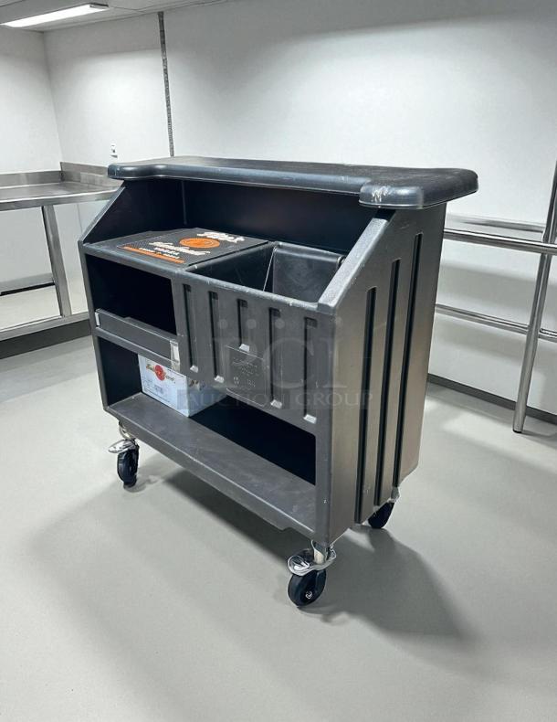 Cambro BAR540110 Cambar® black portable bar, 54", excellent condition, with 5-bottle speed rail, on wheels for easy mobility.