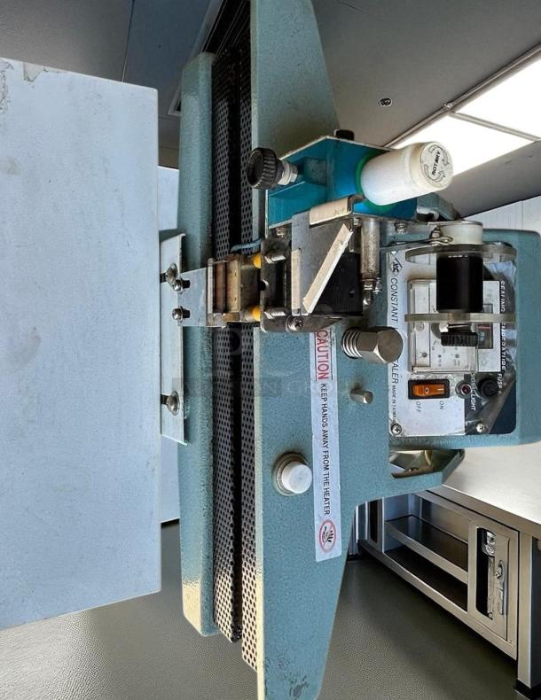 12" Constant Heat Foot Sealer with Lined Jaw, 115V, in excellent condition. Features caution label and control panel.