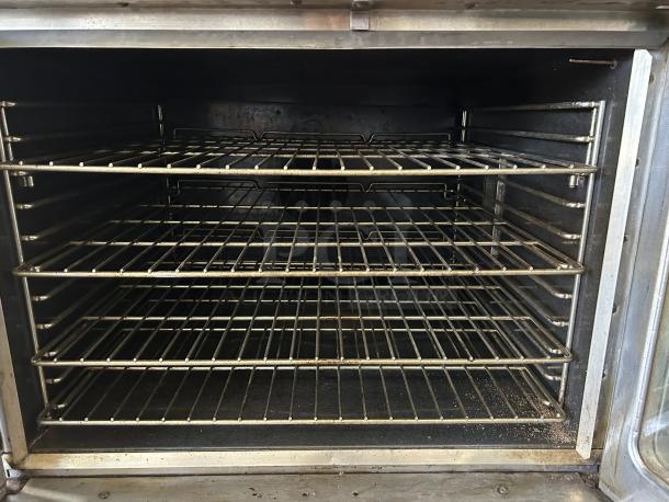 Great condition Southbend PCG50S/SI Platinum single full-size natural gas convection oven, 50,000 BTU, tested. Interior view shows racks.