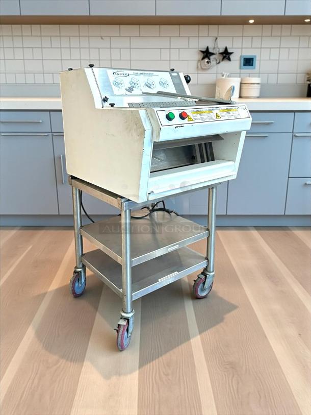 Oliver 732-N front-load bread slicer with bagging scoop; like new condition, tested and working, 115v, on wheeled stand.