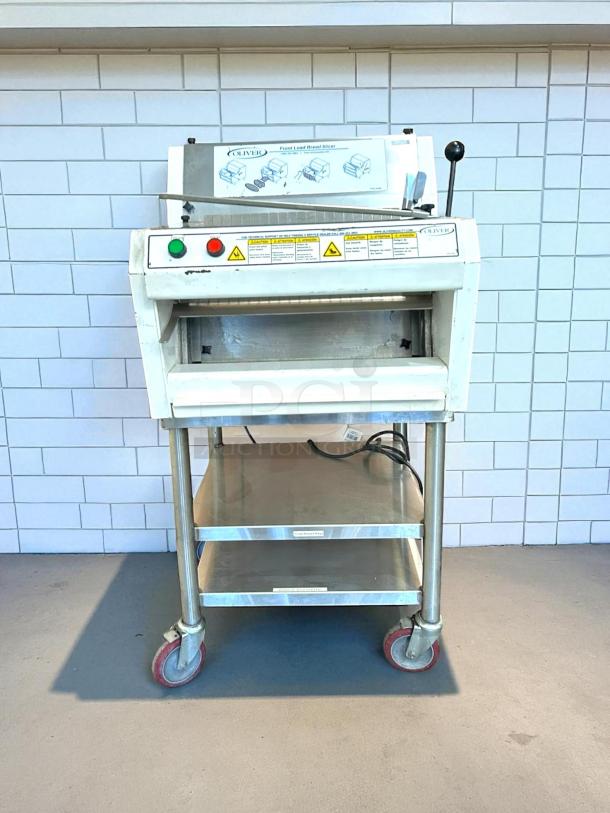 Like new Oliver 732-N bread slicer, front-load, tested working, includes bagging scoop, 115v, stainless steel, red casters.
