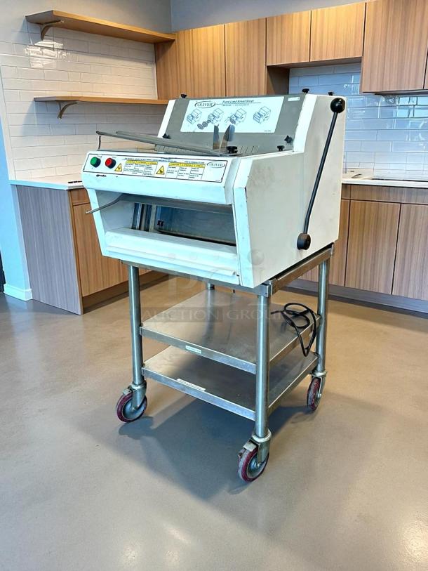 Like new Oliver 732-N front-load bread slicer with bagging scoop, 115v. Tested, working condition. Mounted on mobile stand.
