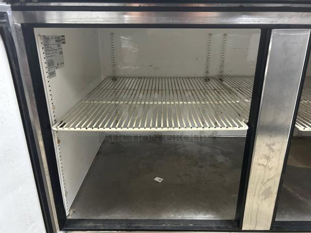 True TWT-67-HC 67" worktop refrigerator with two sections. Interior shelves shown. 115v, great condition, tested and working.