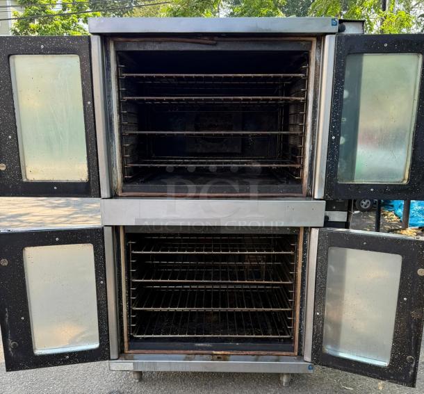 Vulcan Double Stack Convection Oven in stainless steel. Visible wear, dual compartments, open front doors, interior racks shown.