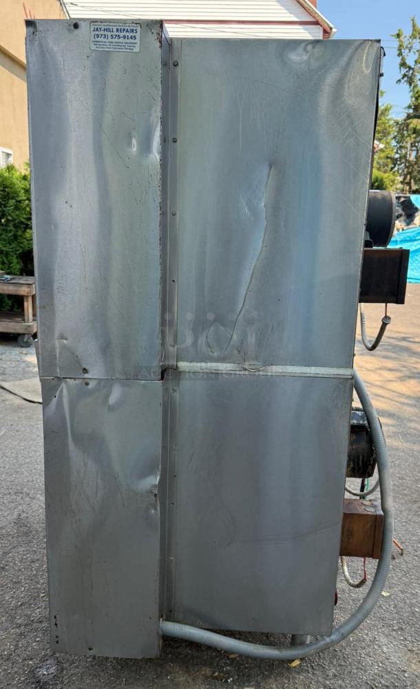 Vulcan Double Stack Convection Oven in stainless steel, side view, visible wear, includes repair service label.