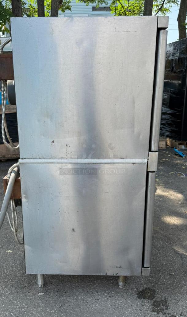 Vulcan stainless steel double stack convection oven, used, with some surface marks and wear, model unknown.