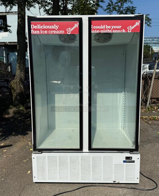 Master-Bilt BLG-48HD two-door glass freezer merchandiser, clear fronts, white exterior, Friendly's branding, outdoor setting.