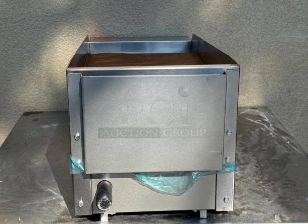 Dukers DCGM12 gas steel countertop griddle, visible clean steel surface, sturdy build, with protective blue wrap at bottom.