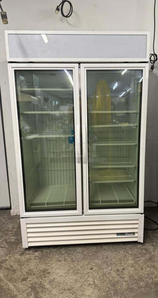 TRUE FLM-54F-TSL01 freezer merchandiser, two glass doors, shelves visible, good condition, True brand label.