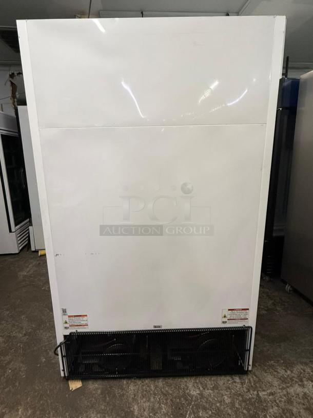 TRUE FLM-54F-TSL01 two-section freezer merchandiser, in good condition, features spacious storage and energy-efficient design.