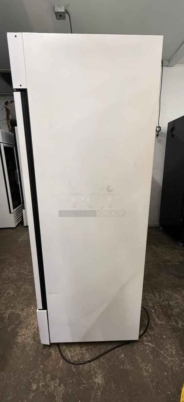 TRUE FLM-54F-TSL01 freezer merchandiser, two-section, full-length. White exterior. Visible power cord, good condition.