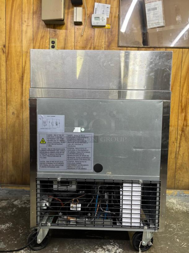 Dukers Salad Prep Station Refrigerator DSP29, tested and working, stainless steel, visible safety and operation labels, on casters.