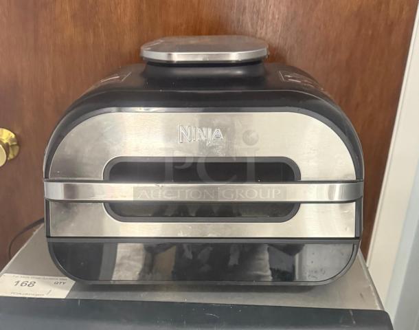 Ninja FG551 Foodi Smart XL 6-in-1 Indoor Grill, stainless steel, gently used, showing power buttons and vent design.
