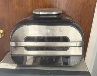 Ninja FG551 Foodi Smart XL 6-in-1 Indoor Grill, stainless steel, gently used, showing power buttons and vent design.