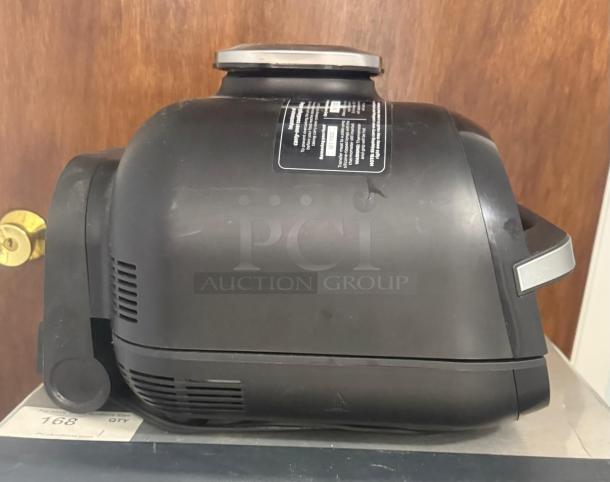Ninja FG551 Foodi Smart XL 6-in-1 Indoor Grill, black, side view, shown in used condition with label on top.
