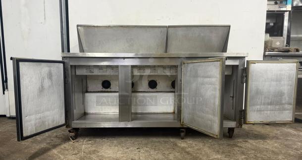 Leader commercial undercounter 3-door refrigerator. Stainless steel, open doors, good condition, worktop style.
