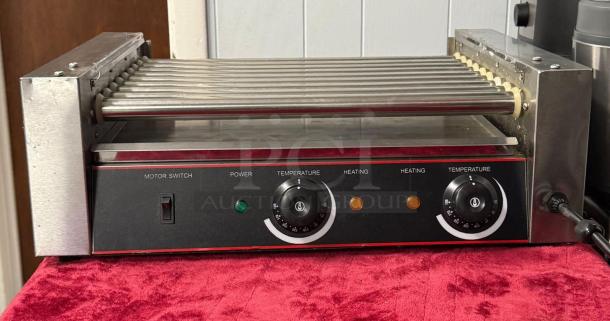 Hot Dog Roller Grill XCJ-9CZ-US, slanted top, manual controls, 120v. Features temperature dials, motor switch, power indicators.