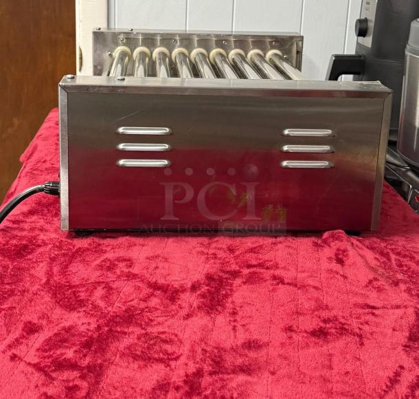 Hot Dog Roller Grill XCJ-9CZ-US, slanted top, manual controls, stainless steel, 120v, used condition, visible side vents.