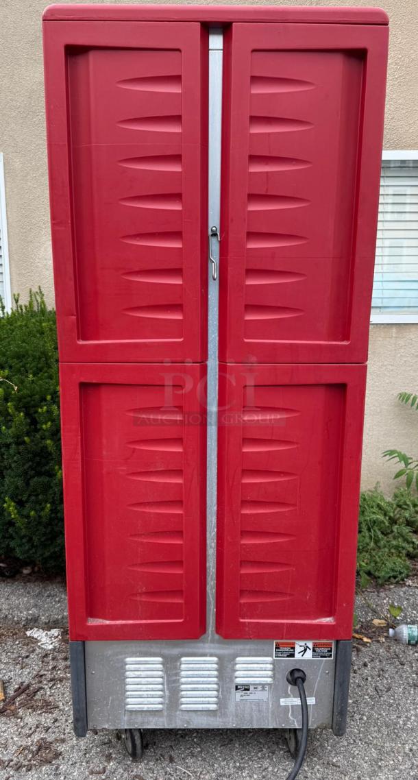 Metro C539-HDS-U full height red insulated mobile heated cabinet, 17-pan capacity, visible electrical cord, outdoor setting.