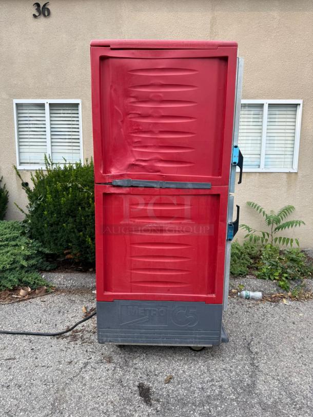 Metro C539-HDS-U full height insulated heated cabinet, red exterior, visible handle, 17-pan capacity, 120v, used condition.
