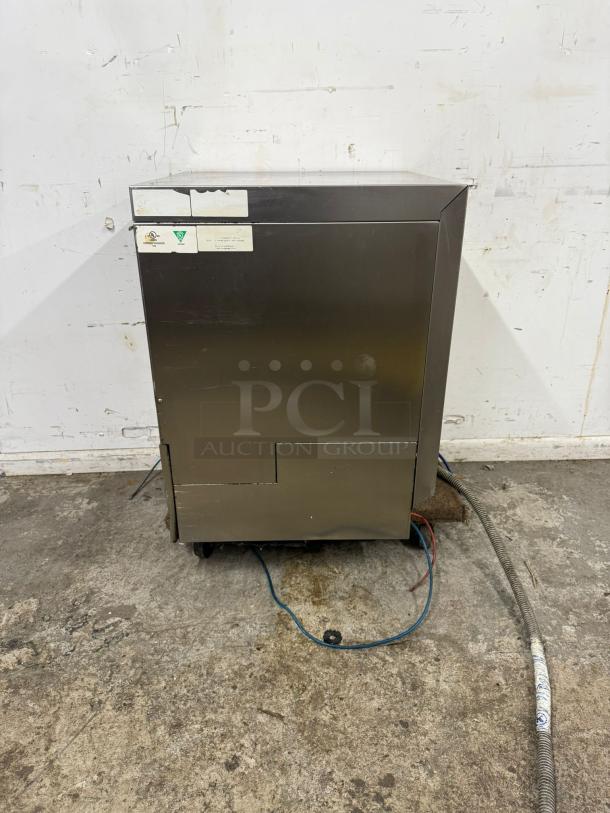 Lamber Deluxe High-Temp Rack Undercounter Dishwasher, stainless steel; visible wear, tags show model details, 30 racks/hr capacity.