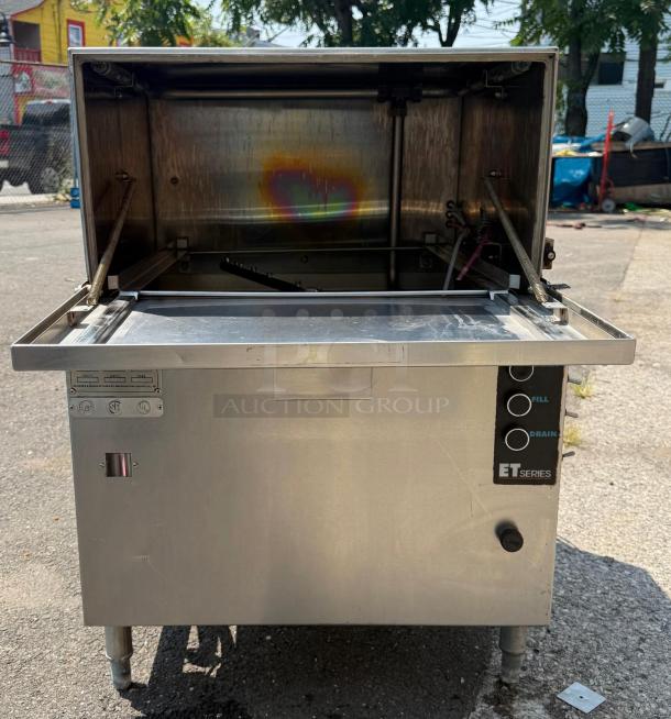 ET Series under counter dishwasher, low temp, single rack, pumped drain. Stainless steel. Model features fill and drain buttons.
