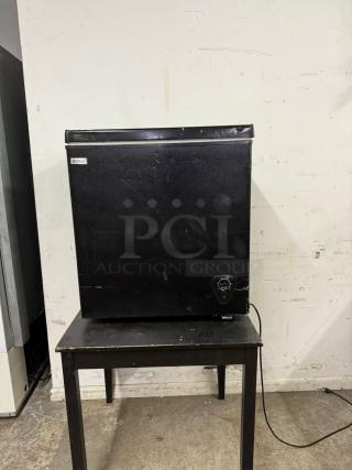 WANAI Deep Chest Freezer 3.0 Cu.Ft, model BC/BD-63, black, visible wear, Wanai branding label present, on a table.