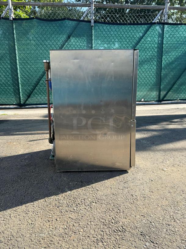 Wareforce UH30-E undercounter dishwasher, stainless steel, energy efficient, 208/230V, outdoor setting, side view.